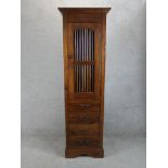A late 20th century Indonesian teak single door food cupboard with four drawers below raised on