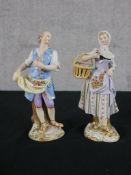 A pair of late 19th/early 20th century hand painted Meissen figures of a man with a cloth filled