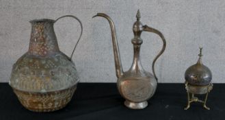 A 20th century Indian brass coffee pot, together with an African embossed brass water jug and a