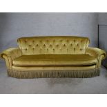 A 19th century gold upholstered button back scroll arm three person sofa. H.88 W.240 D.100cm