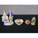 Four pieces of 20th century porcelain to include a Limoges pin dish decorated with a courting