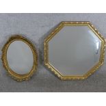 A contemporary octagonal shaped gilt framed wall mirror, together with an oval gilt framed wall