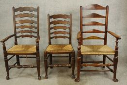 A 19th century mahogany ladder back open arm chair together with a matching single chair and a
