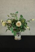 A contemporary Hermes style porcelain cache pot with assorted artificial flowers. H.55cm.