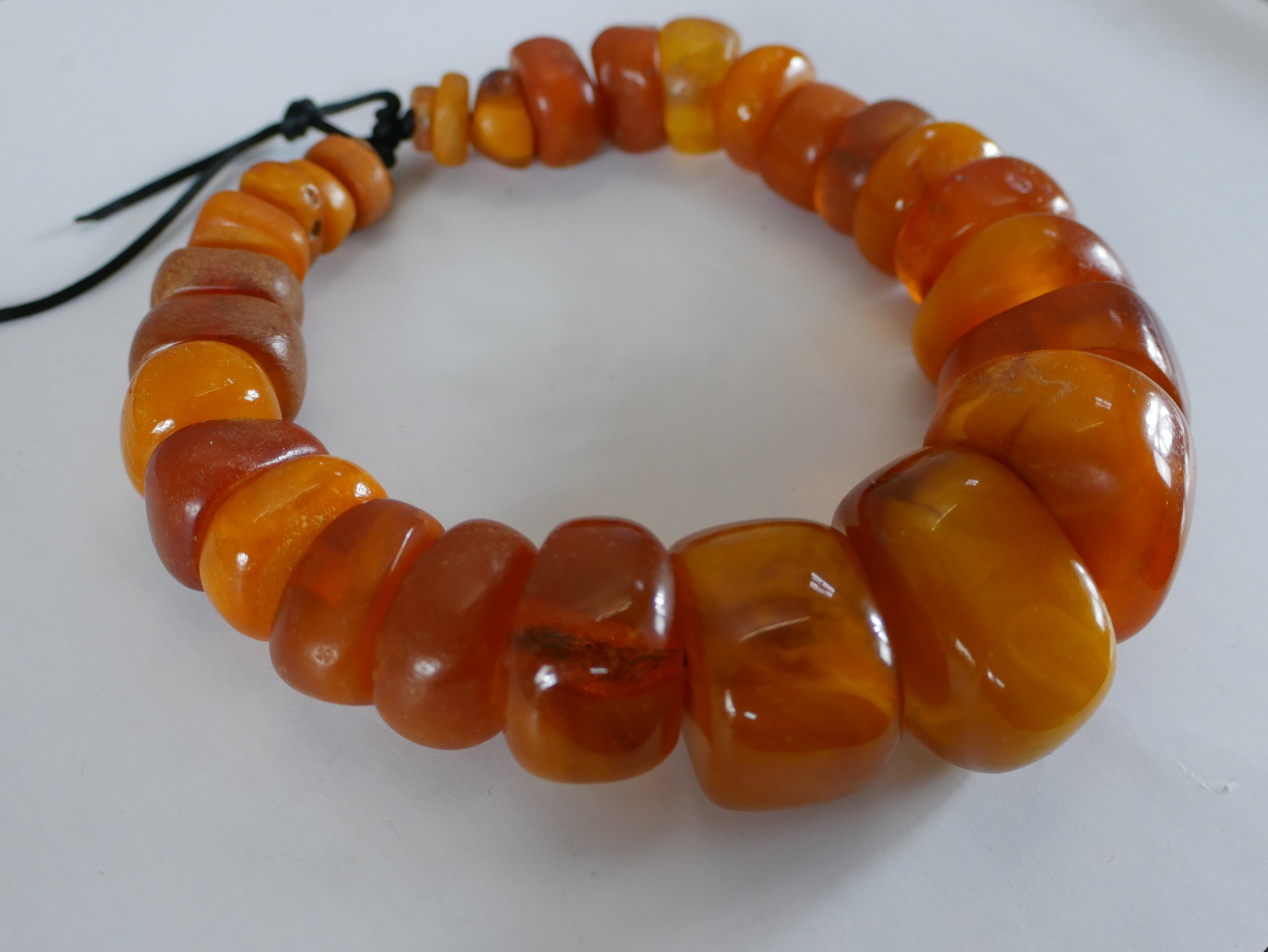 A string of twenty nine graduated African amber beads, the largest bead measuring 4.4cm in length by - Image 2 of 2