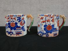 A pair of 19th century English ironstone tankards decorated with floral sprays in the Imari
