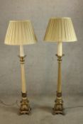 A pair of 20th century Italian style tapering fluted standard lamps raised on four gilded hardwood