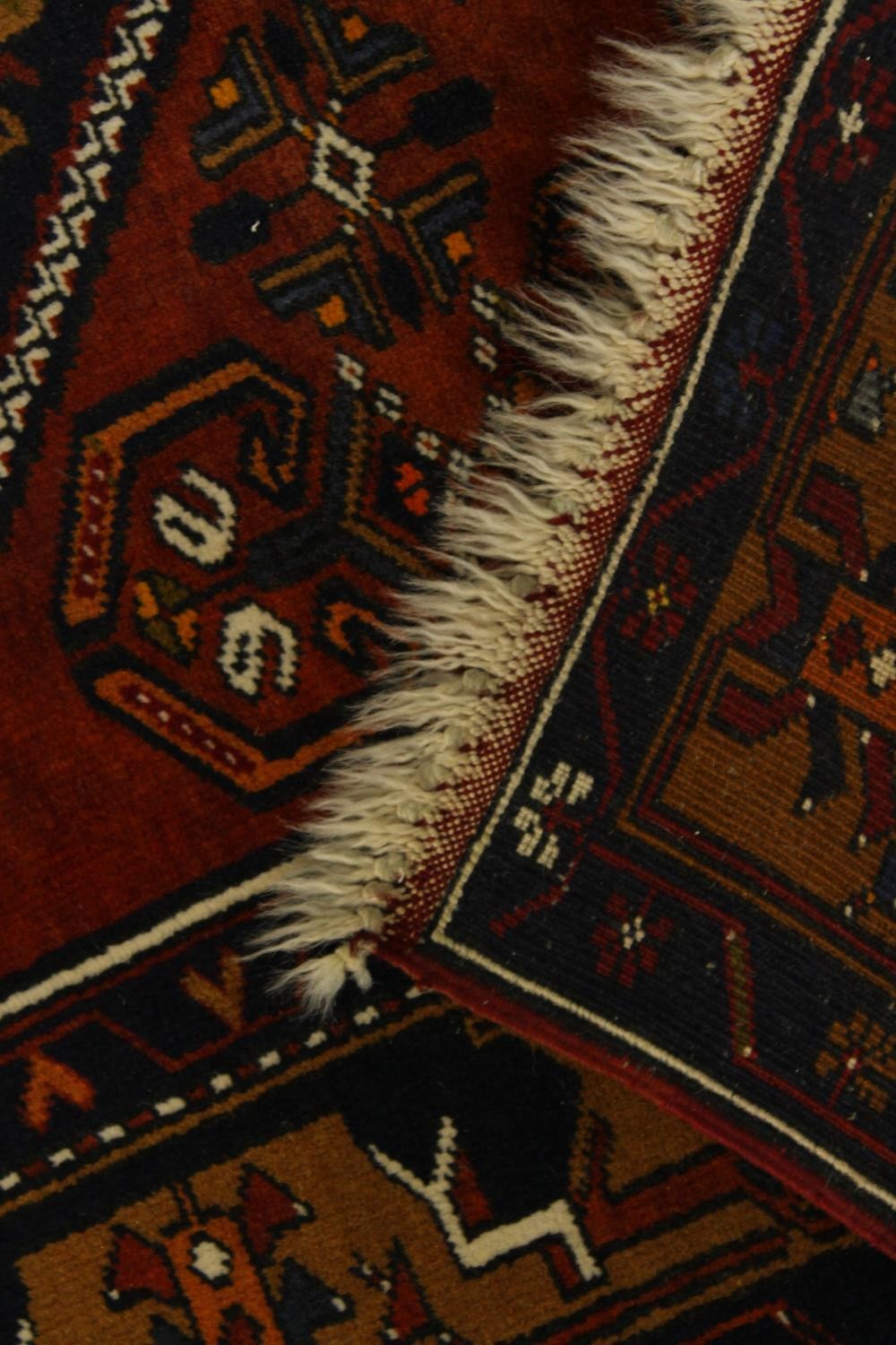 A 20th century red and blue ground Persian woollen rug with all over geometric pattern. L.210 W. - Image 2 of 2