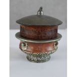 A late 19th/early 20th century Tibetan white metal mounted ritual bowl together with lidded 19th/