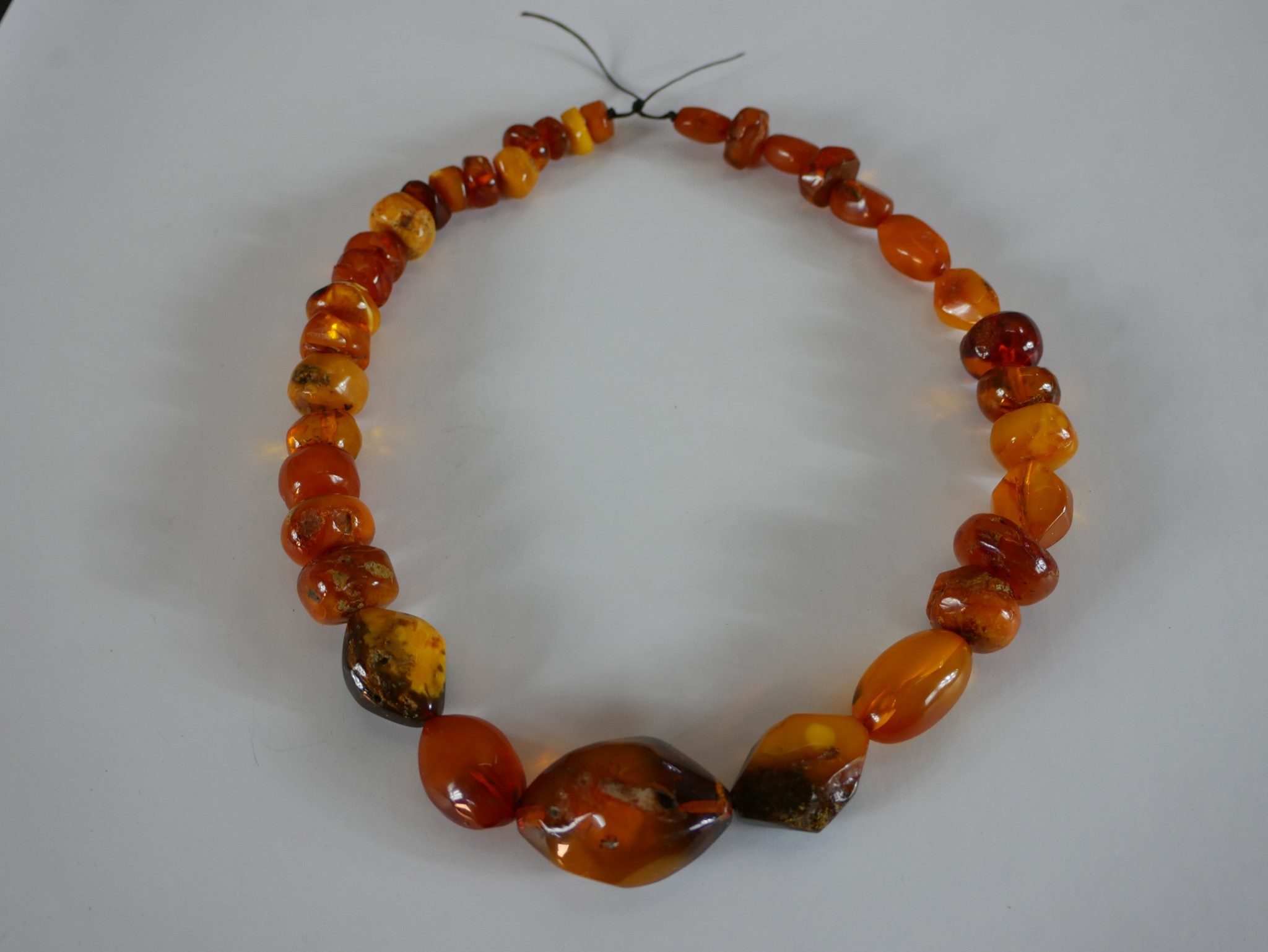 A large string of graduated amber beads, the largest bead measures 3.8cm. L.48cm.