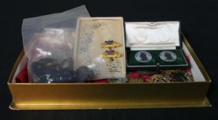 Assorted regimental cap badges, together with some military buttons and medallions.