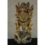 A 20th century carved and painted Balinese tribal figure. H.31 W.20 D.15cm.