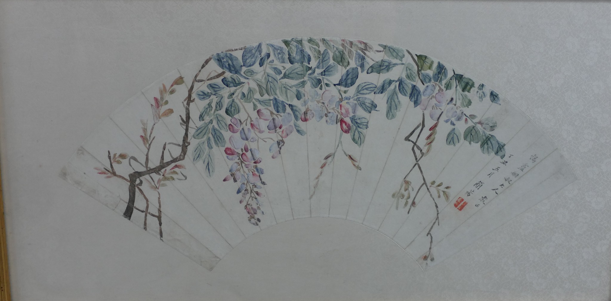 A 20th century hand coloured Japanese fan, with calligraphy and seal mark, framed. H.34 W.64