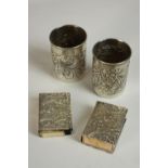 Two Egyptian silver matchbox covers, embossed with floral decoration together with two Egyptian
