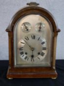 An early 20th century mahogany cased dome topped mantle clock, the silvered dial with two subsidiary