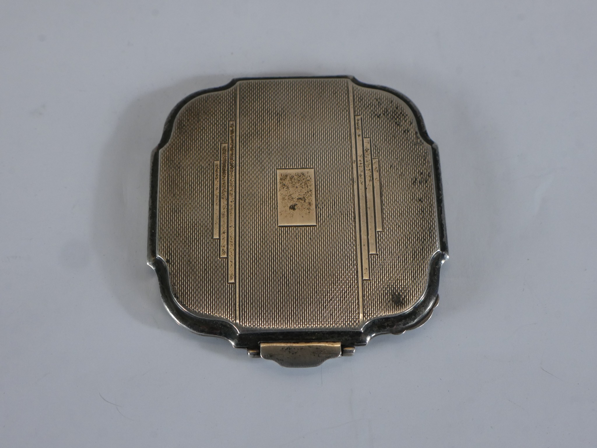 An Art Deco engine turned hallmarked silver ladies compact. H.0.5 W.8 D.7.5cm. 105g gross weight