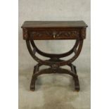 A 19th century Italian style carved oak single drawer side table raised on double 'X' supports