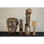 A 20th century carved West African wooden doll, a carved African tribal mask and two carved tribal