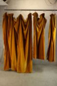 Three 20th century gold coloured velvet lined curtains. L.215cm. (each)