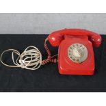 A 20th century red Bakelite electric telephone dial with wind up dial. H.15 W.25 D.22cm