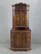 A contemporary Indonesian teak and mother of pearl inlaid corner cupboard with twin cupboard doors