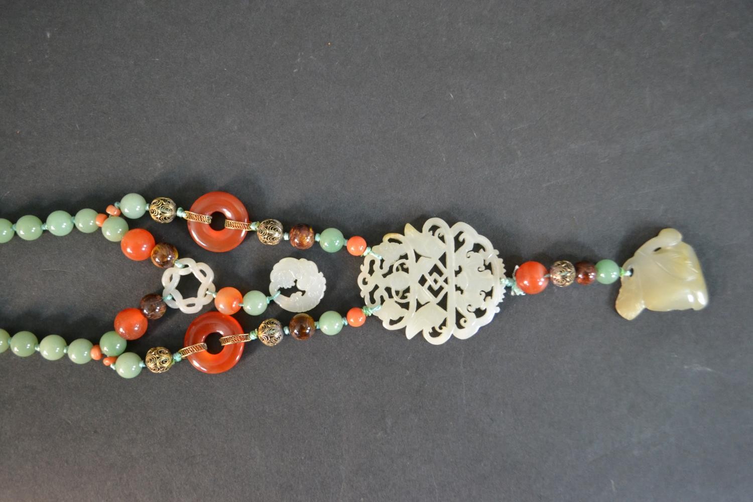 A boxed long ceremonial necklace silver gilt, jade, coral, carnelian and tigers eye pendant - Image 3 of 8