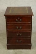 A contemporary Georgian style mahogany effect two drawer filing cabinet raised on plinth base and