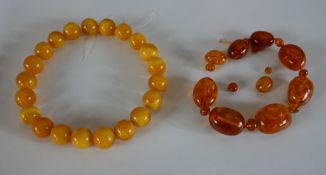 Two strings of amber beads, including a string of large amber beads (measuring 3cm) and smaller