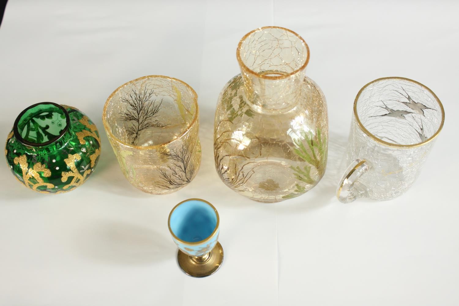 Three pieces of 20th century crackle glass, together with a green Bohemian glass and gilt painted