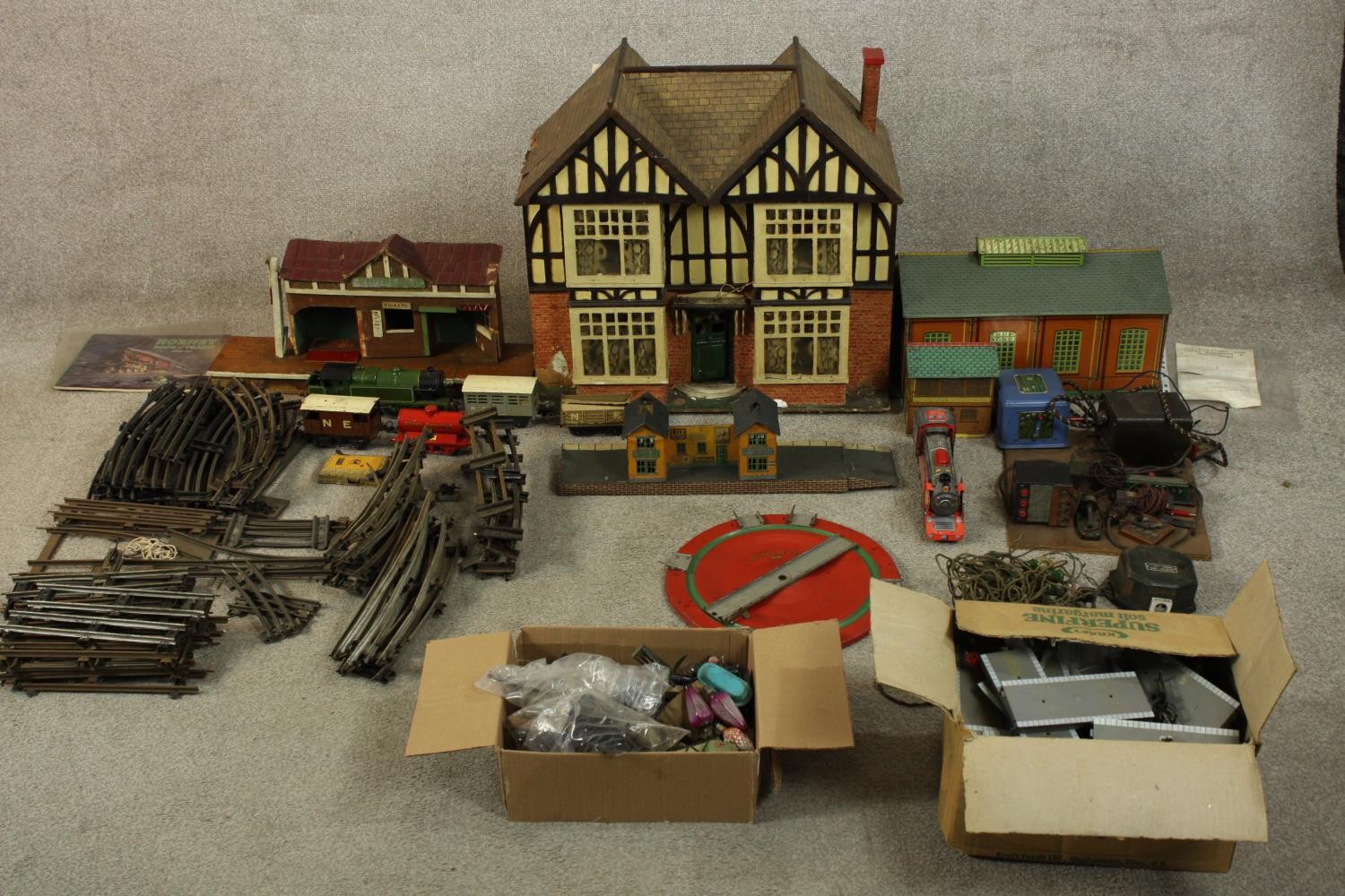 A 20th century tin plated model trainset together with assorted buildings, trains and track. H.58