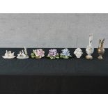 Various porcelain ornaments to include four floral encrusted ornaments, two swan porcelain swan