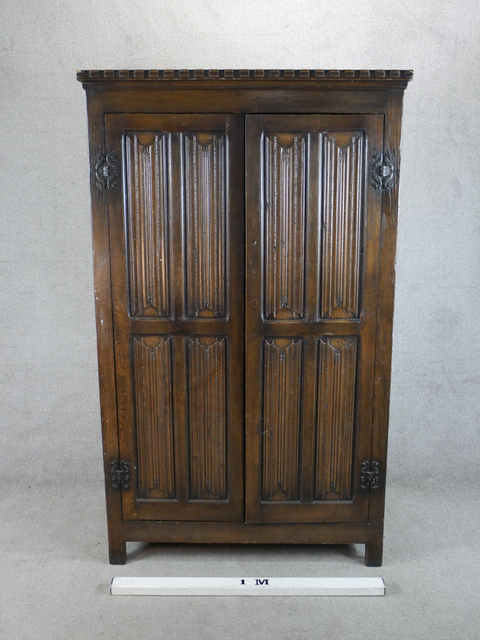 A 20th century stained oak twin door wardrobe with panels of linen fold decoration raised on - Image 2 of 5