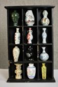 Franklin Mint, a set of twelve miniature Oriental ceramic vases and jars contained within a