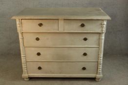 A contemporary painted pine chest of two short over three long drawers with brass swing handles