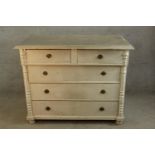 A contemporary painted pine chest of two short over three long drawers with brass swing handles