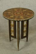 A 20th century North African/Indian circular painted topped folding occasional table, decorated with