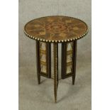 A 20th century North African/Indian circular painted topped folding occasional table, decorated with