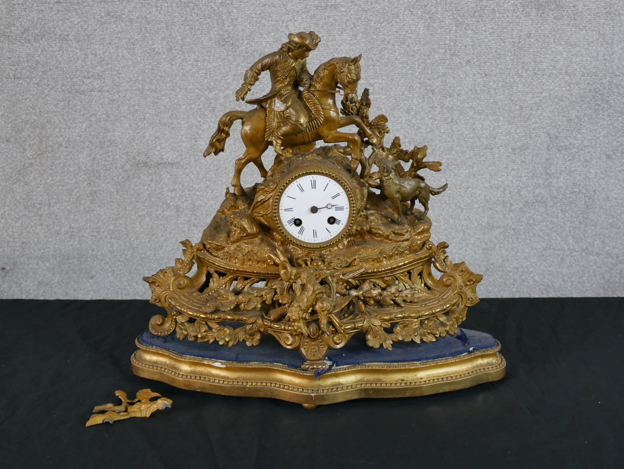 A late 19th/early 20th century gilded spelter mantle mantle clock surmounted with a soldier on