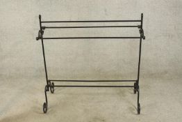 A contemporary black painted iron scroll work towel rail. H.90 W.89cm.