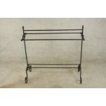 A contemporary black painted iron scroll work towel rail. H.90 W.89cm.