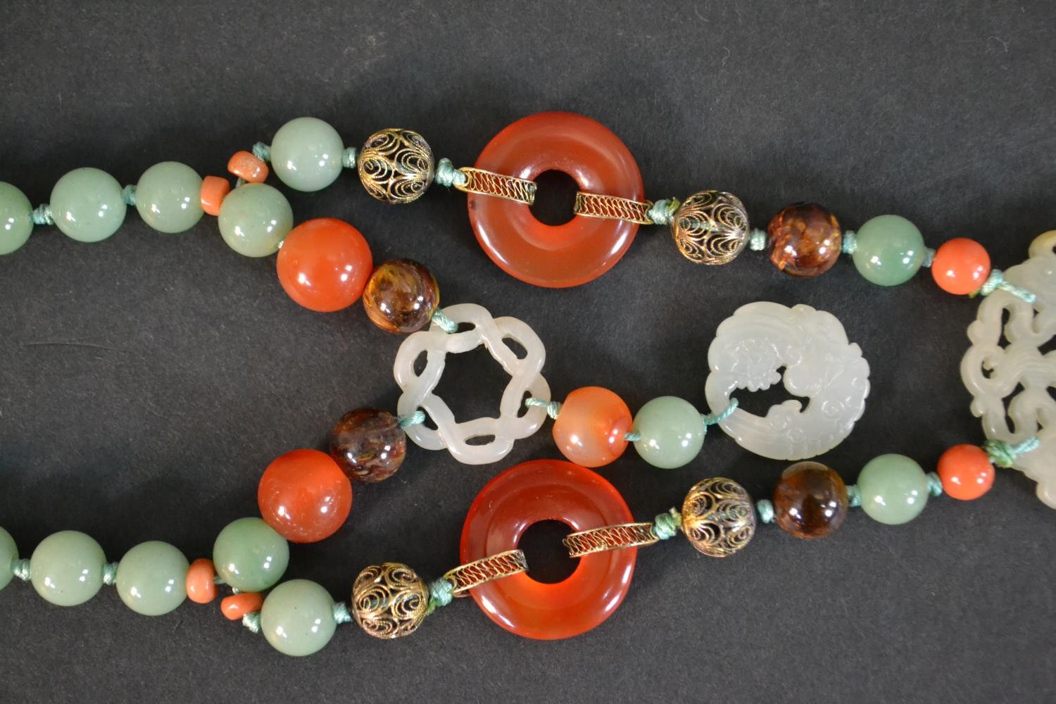 A boxed long ceremonial necklace silver gilt, jade, coral, carnelian and tigers eye pendant - Image 5 of 8