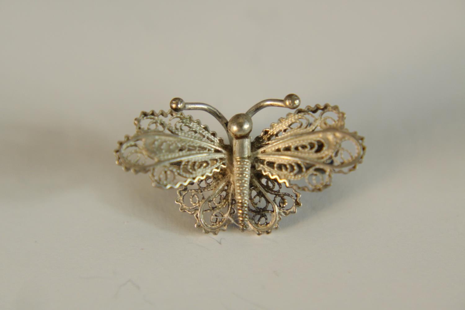 A collection of mixed jewellery, including a silver filigree wirework butterfly brooch, a black - Image 4 of 24