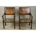 A pair of 17th century oak and leather open arm dining chairs raised on turned supports and feet.