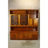 A large contemporary mahogany effect dresser/cabinet with shelf back and two glass doors with drinks