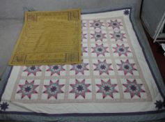 A 20th century patchwork quilt together with a 20th embroidered tapestry Latin text. H.250 W.250cm