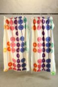 A pair of mid 20th century curtains with printed colourful circles decoration. L.160cm. (each)