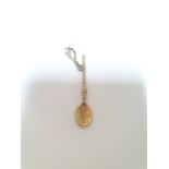 An Edwardian 9ct gold engraved charm in the form of a Welsh love spoon, the bale set with a