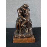 After Auguste Rodin (1840-1917, French) an Austin Sculpture of The Kiss, raised on square hardwood