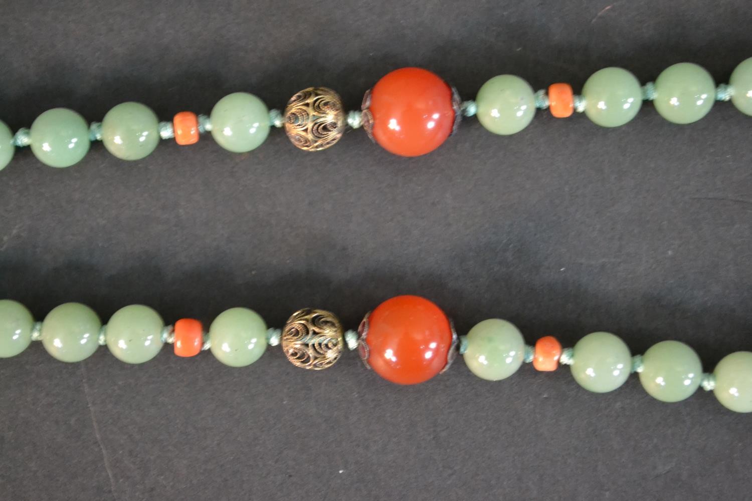 A boxed long ceremonial necklace silver gilt, jade, coral, carnelian and tigers eye pendant - Image 6 of 8