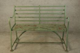A contemporary Victorian style green painted cast iron garden bench. W.122 D.60cm.